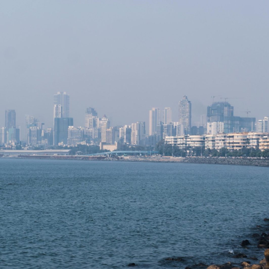 Captivating view of Marine Drive with Mumbai skyline and Arabian Sea under a clear sky.